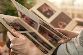 a person holding book of pictures